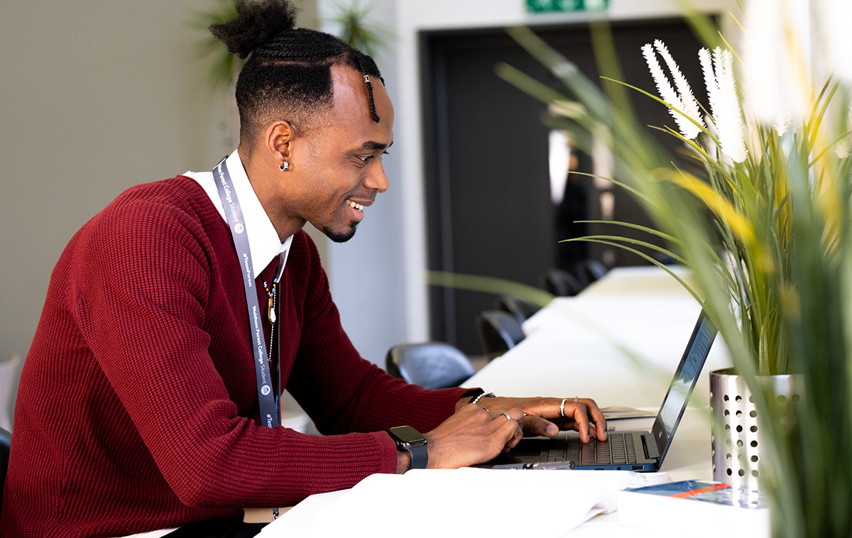 Adult learner working on a laptop