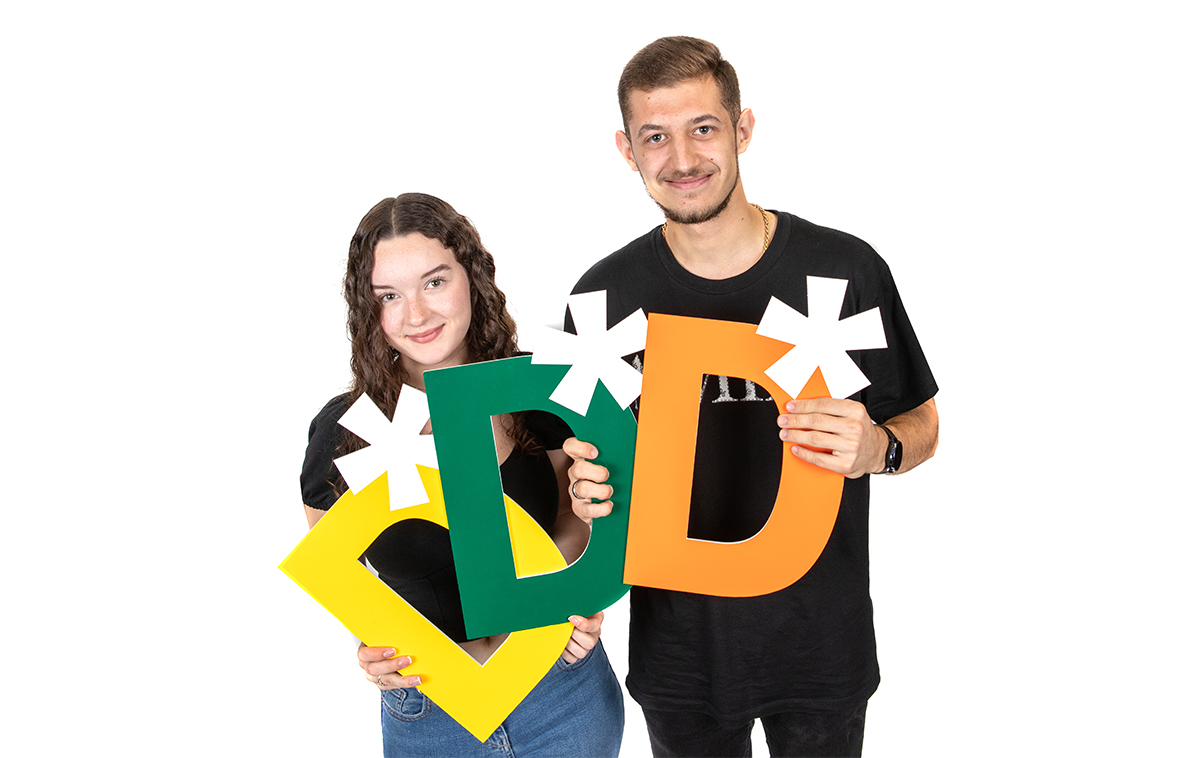 Students holding distinction signs