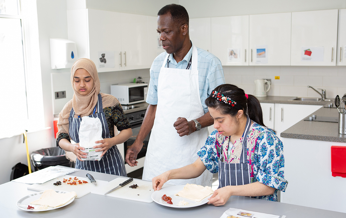 Students working in kitchen with tutor