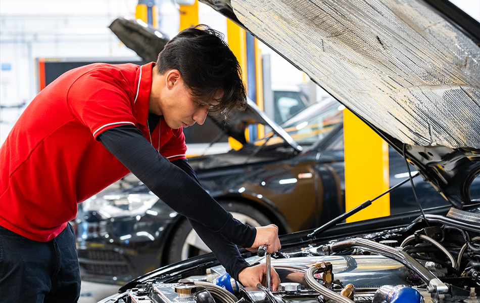 Student working on a car engine