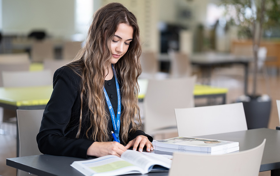 Student studying a coursework book about business