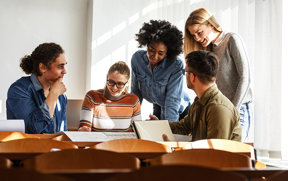 Students at a table collaborating on school work
