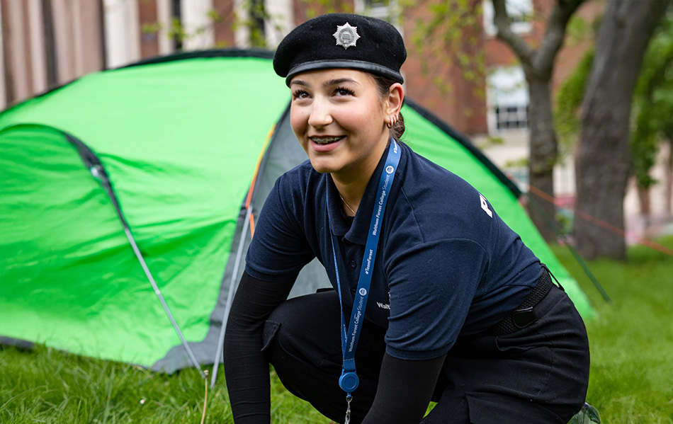 Public service student setting up a tent