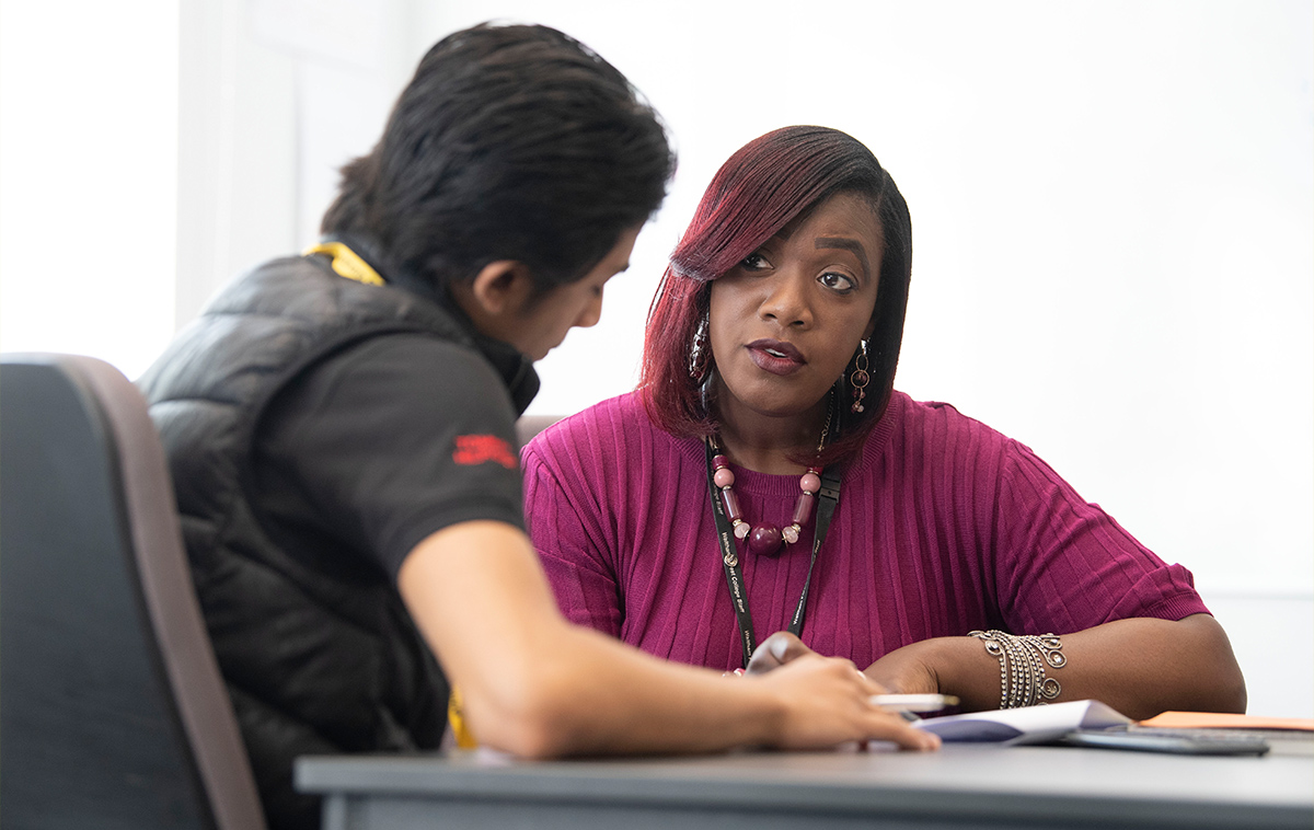 Student speaking to college advisor