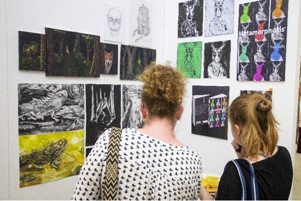 Two women look at artwork