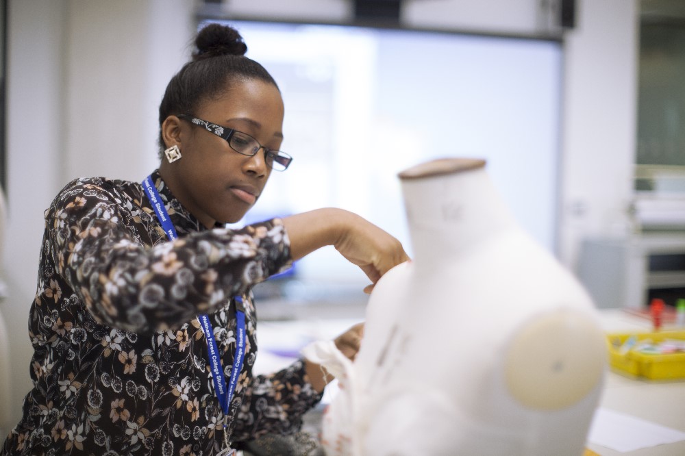 Image of person working on a manikin 