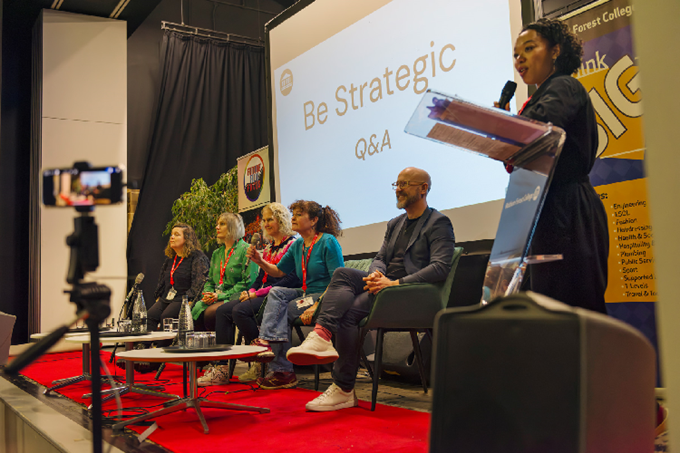 Panelist speaks at stand on stage