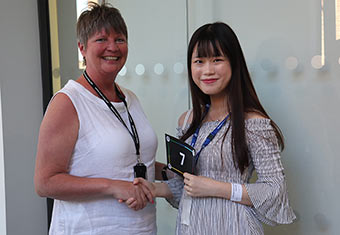 Student shaking hand with reward