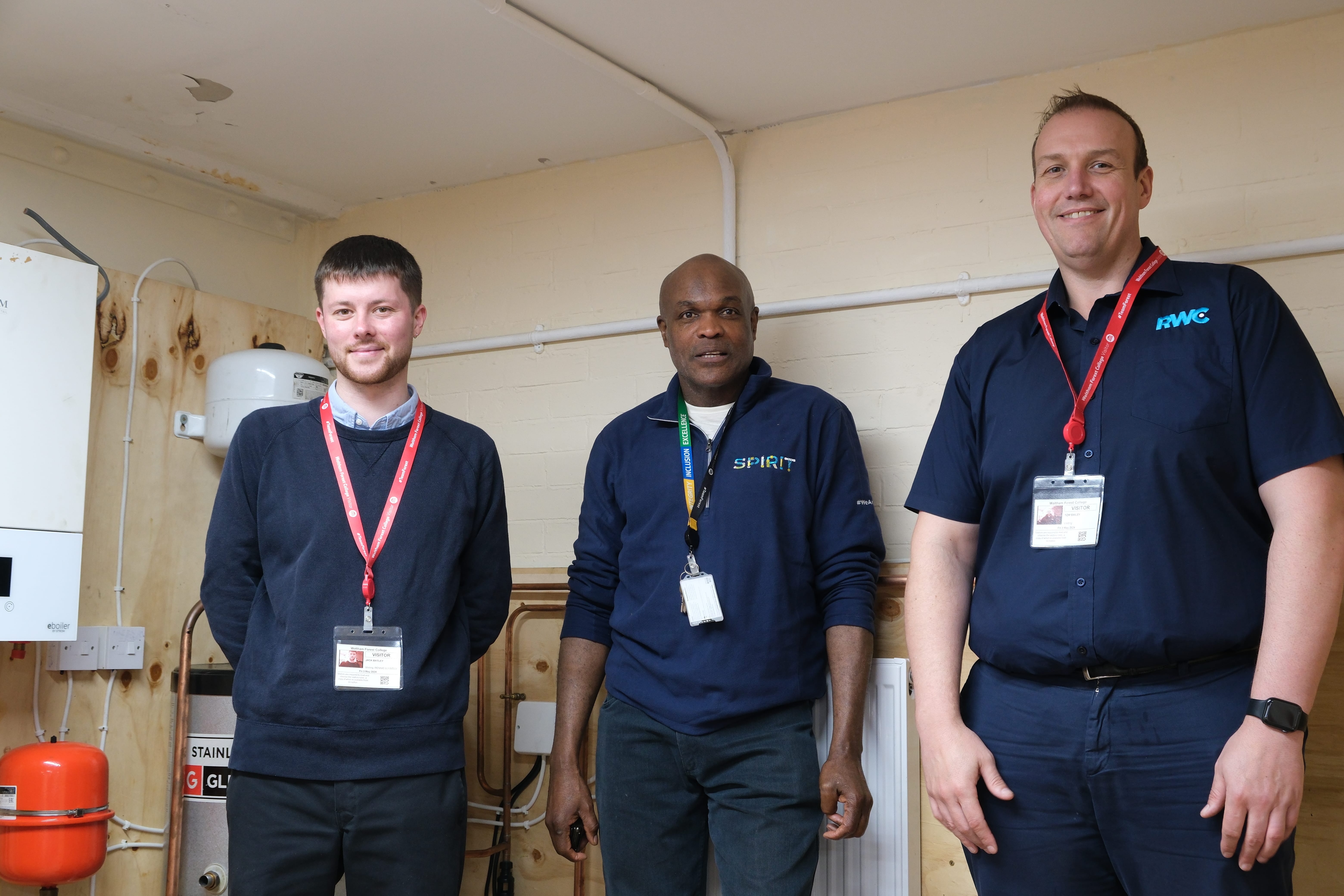 Plumbing tutor Rennie stands with judges