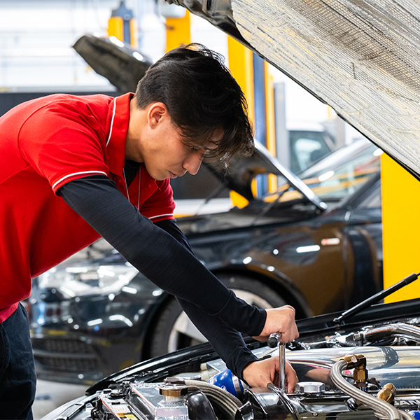Student working on a car engine