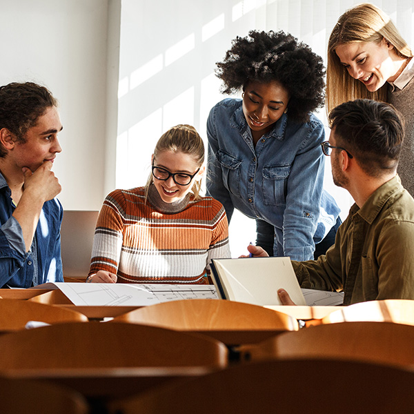 Students at a table collaborating on school work