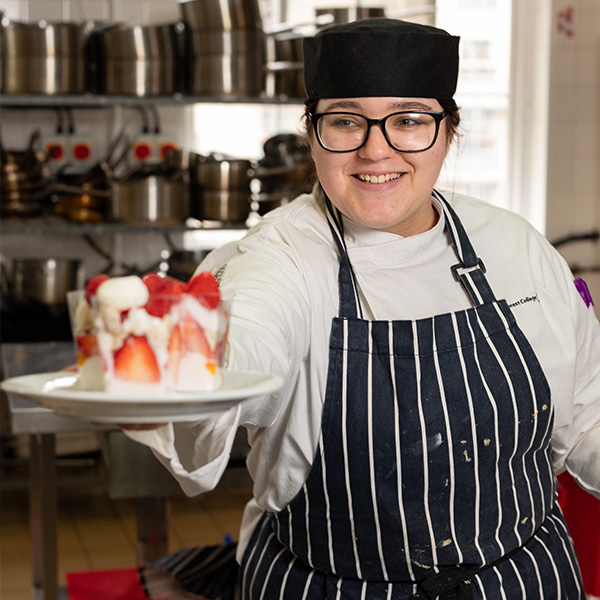 Catering student presenting a strawberry dessert